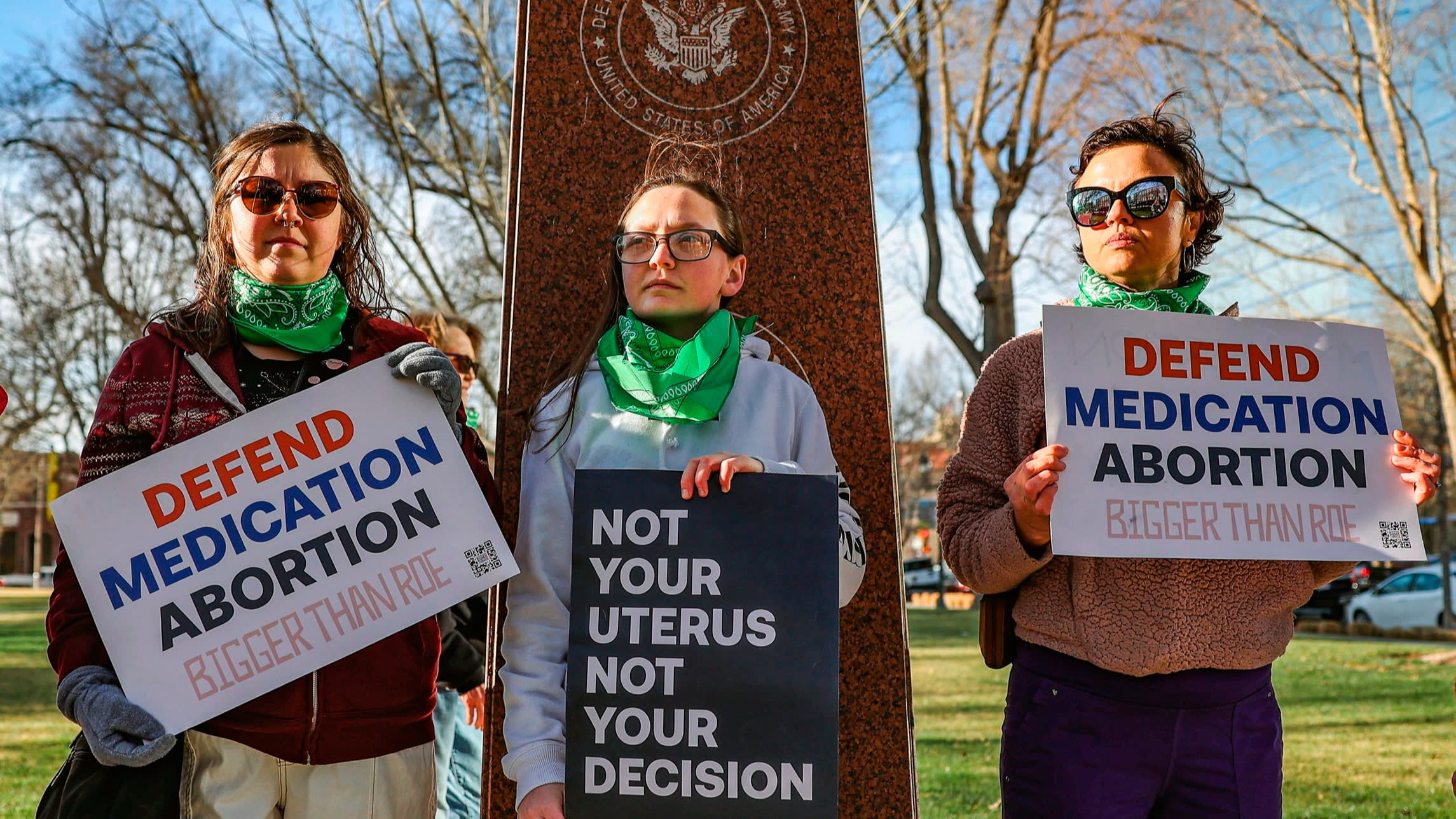 Three members of the Women’s March group protest in support of access to abortion medication outside the Federal Courthouse in Amarillo, Texas