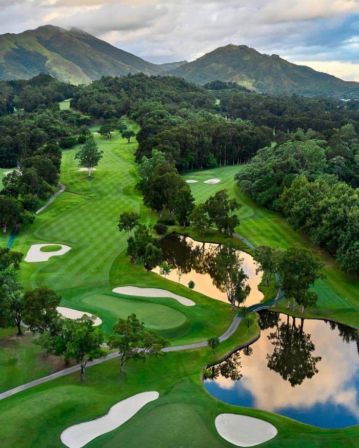 Bunkers, ponds and trees on a course at Hong Kong Golf Club, with forested hills in the distance