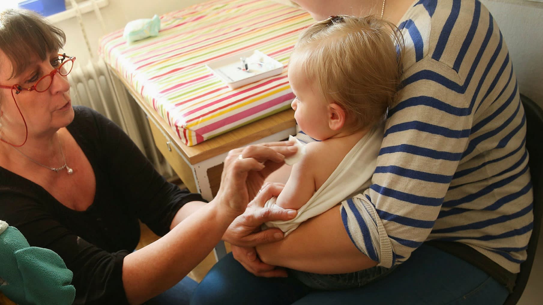 A baby being given a vaccination